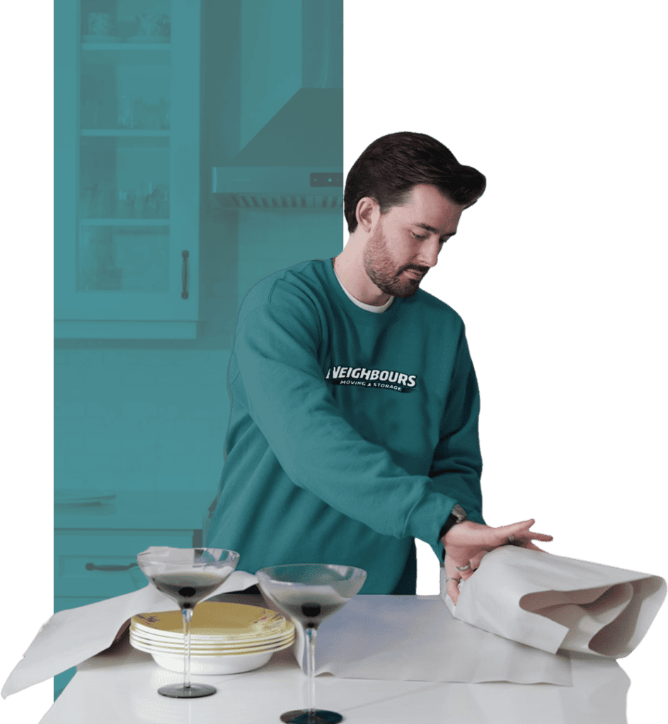 Professional mover preparing packing materials in a modern kitchen.