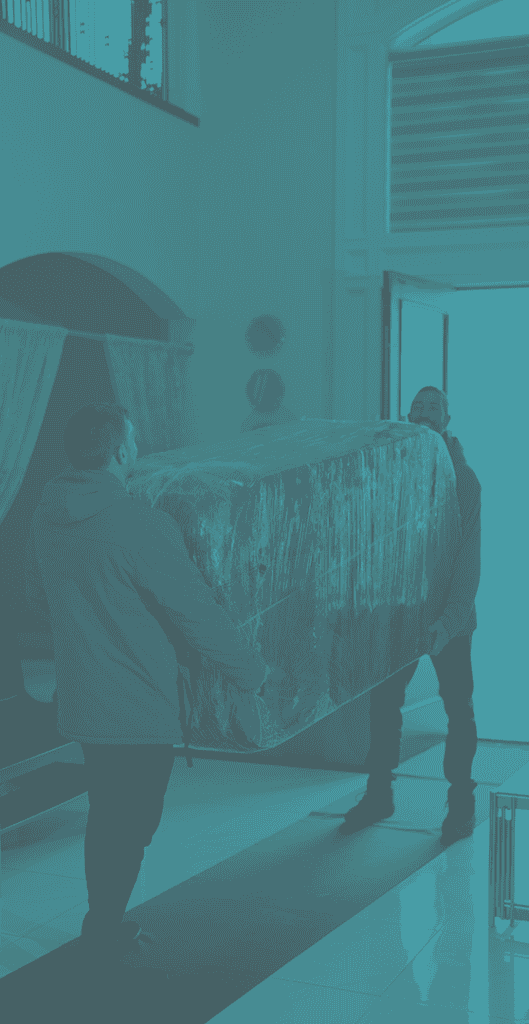 Two movers transporting a large furniture piece during a commercial move.