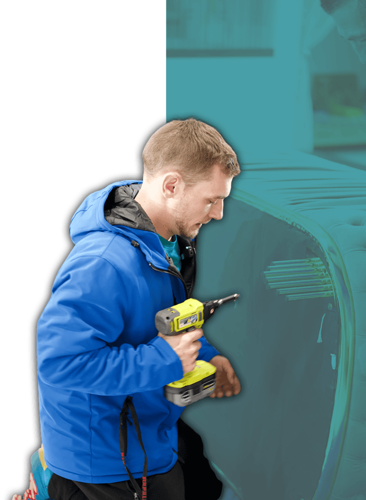 Technician installing storage unit with power drill at Neighbours Moving & Storage.
