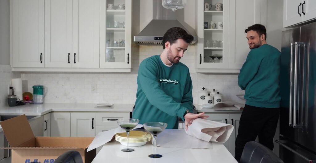Efficient movers packing kitchen items for a smooth relocation process.