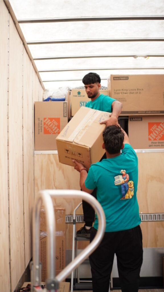 Aurora movers carefully load and organize moving boxes inside a moving truck to maximize space and keep belongings secure during transport