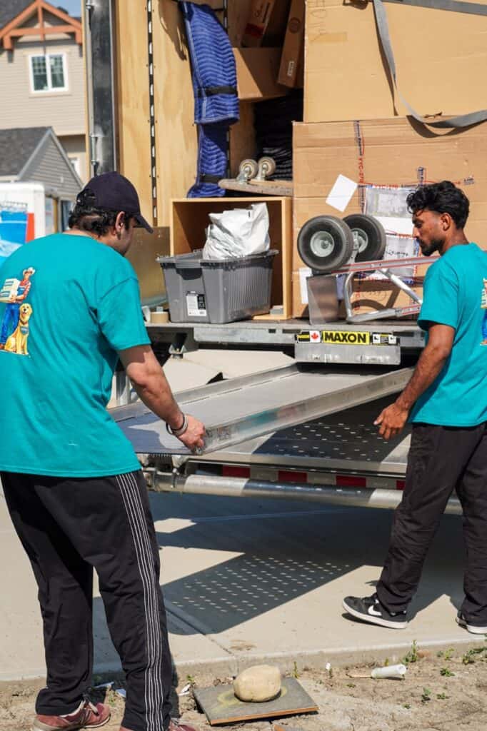 Movers loading a truck with boxes and furniture for a move.